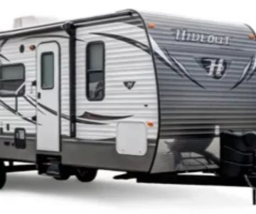Side exterior view of The Easy Hideaway travel trailer from Iowa RV Rental, delivered and campsite ready